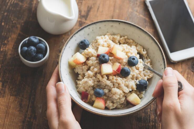 Eating healthy breakfast. Oatmeal porridge in bowl